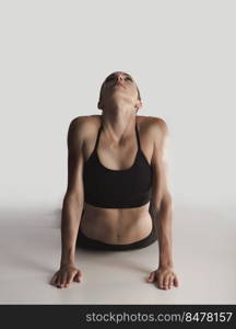 Shot of a young woman doing stretching exercises 