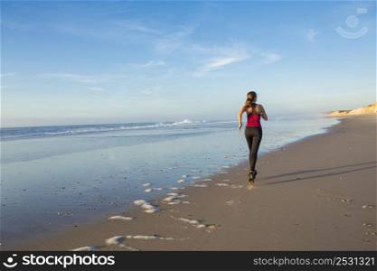 Shot of an attractive young woman running outdoor at the beach