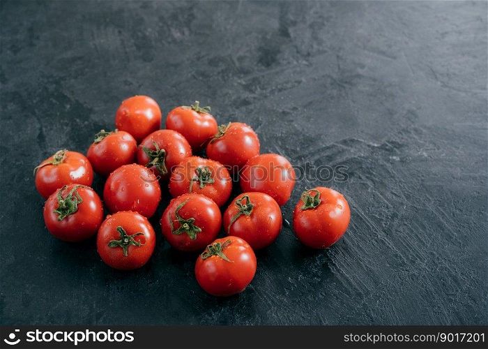 Shot of fresh tomatoes with drops. Heilroom vegetables. Fresh food. Harvest. Copy space. Organic tomatos. Top view. Nutrition concept