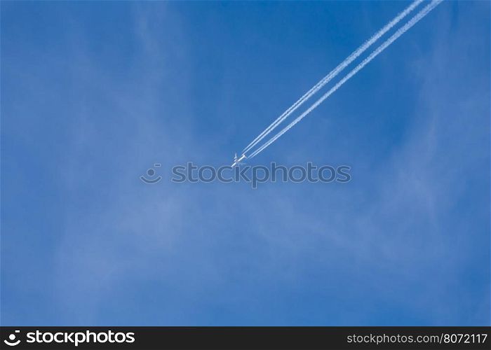 Shot of long trail of jet plane on blue sky