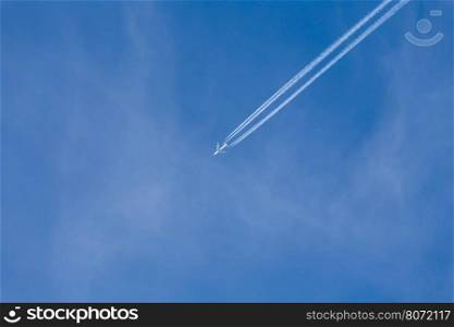 Shot of long trail of jet plane on blue sky
