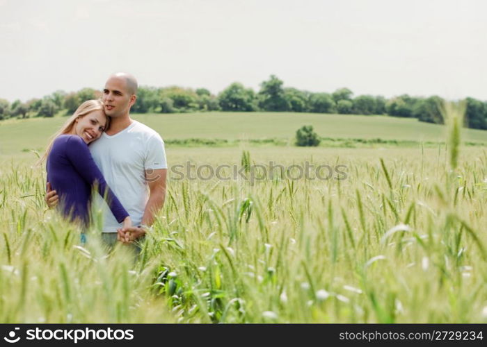 Shot of young couple hugging and holding hands outdoor