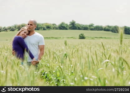 Shot of young couple hugging and holding hands outdoor