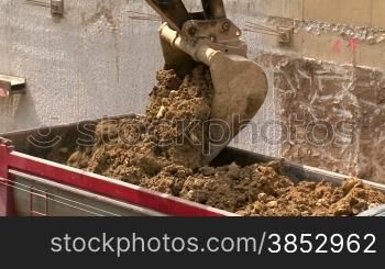 Shots of civil works. Construction equipment and workers.Excavator moving sand into a truck.Bulldozer excavating equipment.Truck driver in an excavation.