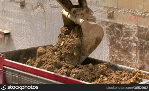 Shots of civil works. Construction equipment and workers.Excavator moving sand into a truck.Bulldozer excavating equipment.Truck driver in an excavation.