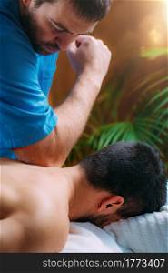 Shoulder blade or scapula pone physical therapy. Physiotherapist massaging patient&rsquo;s shoulder. Sports injury treatment.. Shoulder Blade or Scapula Bone Physical Therapy