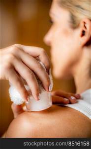 Shoulder cryotherapy ice massage. Hands of a therapist placing ice directly onto a painful shoulder to relieve pain, reduce inflammation and swelling and promote healing.. Shoulder Cryotherapy Ice Massage.