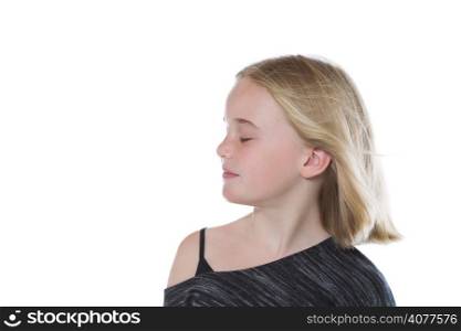 Shoulders up closeup side view of pretty young girl, eyes closed, isolated on white