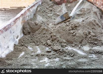 shovel placed on a pile of sand for construction work