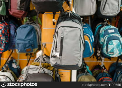Showcase with backpacks in sports shop, nobody. Summer active leisure, showcase with bags, professional travelling equipment. Showcase with backpacks in sports shop, nobody