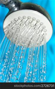 Shower with drops of water on a blue background.