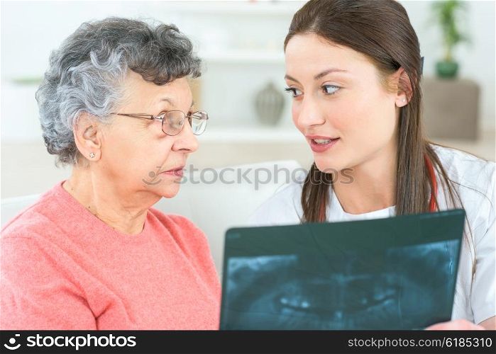Showing x-ray to elderly patient
