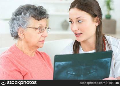 Showing x-ray to elderly patient