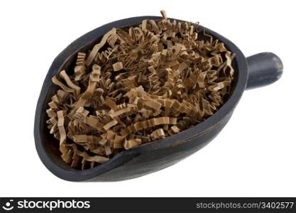 shredded brown packing paper on a rustic wooden scoop isolated on white - recycling or reusing concept