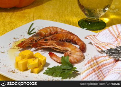 shrimp and cubes of pumpkin on black background