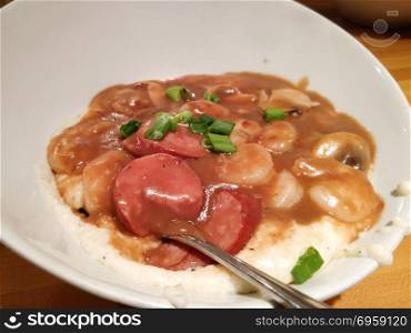 shrimp and grits with sausage on dinner table