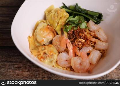 Shrimp dumpling with shrimp on wood background