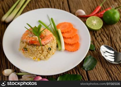 Shrimp fried rice on a white plate on a wooden table