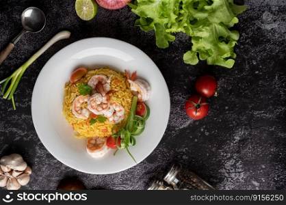 Shrimp fried rice with tomatoes Carrots and scallions on the plate.
