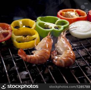 shrimp grilled on barbecue stove with chilli and onion ring
