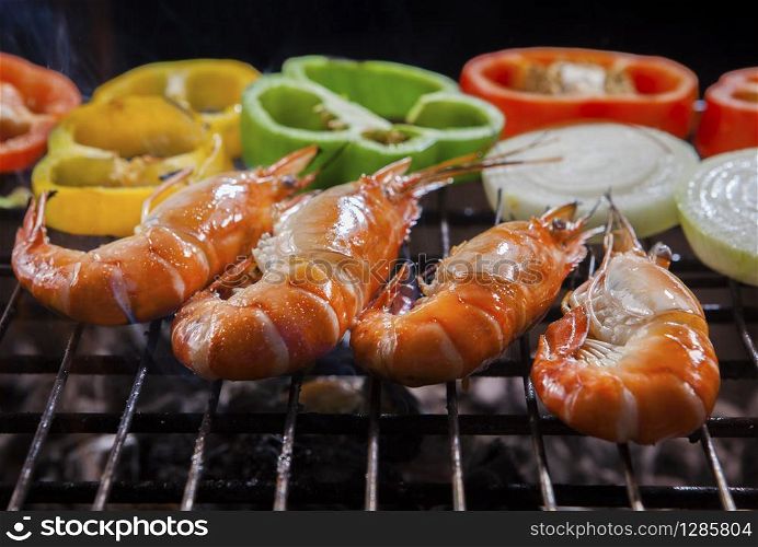 shrimp grilled on barbecue stove with chilly and onion ring