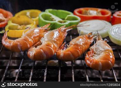 shrimp grilled on barbecue stove with chilly and onion ring