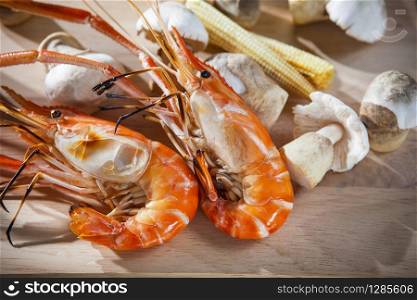 shrimp grilled with corn and mushroom on clean wood plate