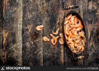 Shrimp in a bowl. On a wooden background.. Shrimp in a bowl.