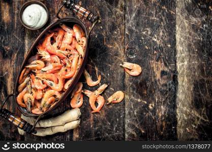 Shrimp in a bowl. On a wooden background.. Shrimp in a bowl.