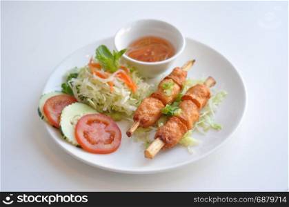 Shrimp on Sugarcane. A traditional Vietnamese dish. Shrimp paste wrapped around sugarcane and grilled. Served with fresh vegetable and homemade sauce.