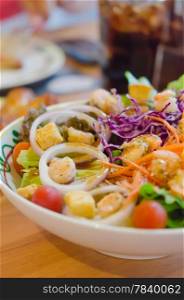 shrimp salad in bowl. close up shrimp and vegetable salad with sauce in white bowl