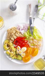 Shrimp salad with avocado, tomatoes and quail eggs. diet food
