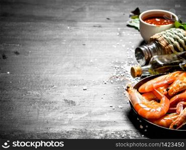 Shrimp sauce, olive oil and salt. On the black chalkboard.. Shrimp sauce, olive oil and salt.