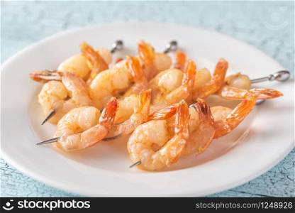 Shrimp skewers on the white plate