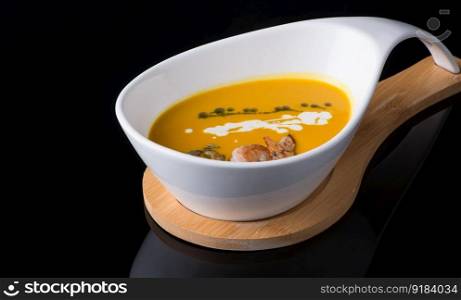 shrimp soup in a white cup on a black background, isolated. dish on black background