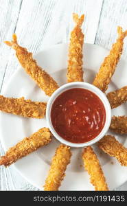 Shrimp tempura with sauce on the plate: top view