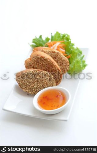 Shrimp Toast. Shrimp paste spread on French bread, deep - fried and served with homemade sauce.