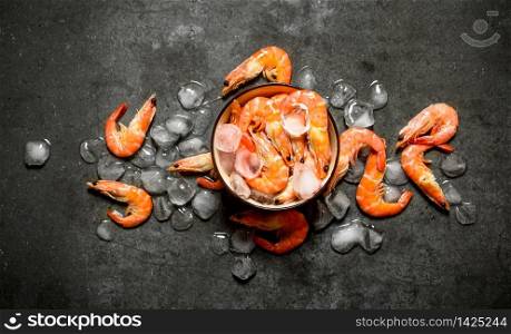 Shrimp with ice in a bowl . On a stone background.. Shrimp with ice in a bowl .