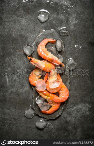 Shrimp with ice . On a stone background.. Shrimp with ice .