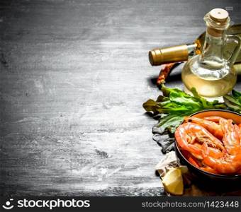 Shrimp with lemon and fresh herbs. On the black chalkboard.. Shrimp with lemon and fresh herbs.