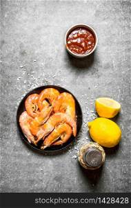 Shrimp with lemon and sauce. On the stone table.. Shrimp with lemon and sauce.