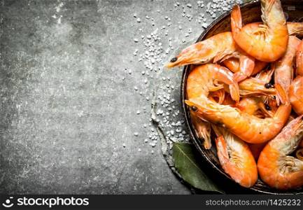Shrimp with salt and Bay leaf. On the stone table.. Shrimp with salt and Bay leaf. n the stone table.