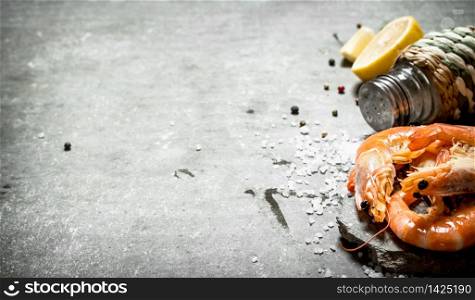Shrimp with salt and lemon. On the stone table.. Shrimp with salt and lemon.