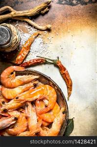 Shrimp with salt and spices. On an old rustic background .. Shrimp with salt and spices.