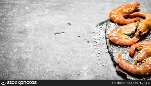 Shrimp with salt. On a stone background.. Shrimp with salt.