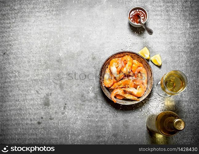 Shrimp with white wine and lemon. On the stone table.. Shrimp with white wine and lemon.