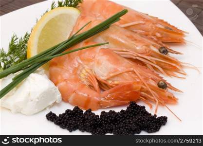 shrimps and caviar. a plate with fresh caviar, chive and shrimps