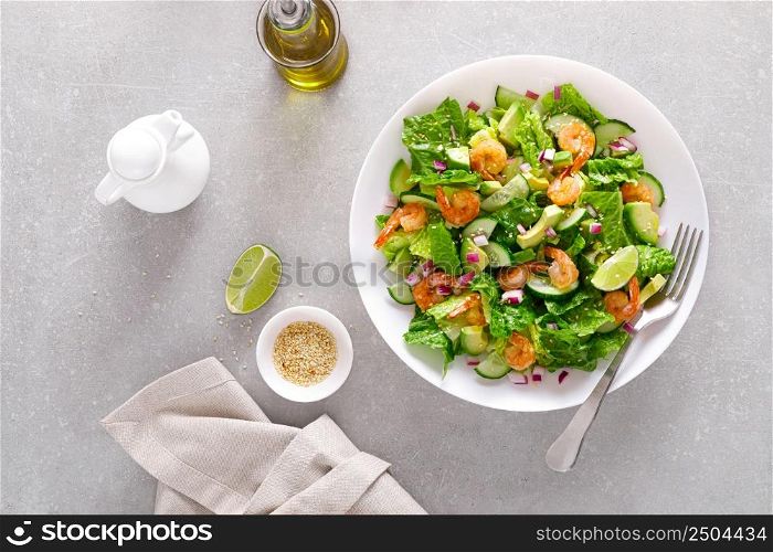 Shrimps avocado salad with cucumbers and lettuce. Top view, flat lay