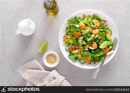 Shrimps avocado salad with cucumbers and lettuce. Top view, flat lay