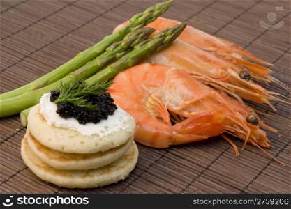 shrimps, caviar and asparagus. a finger food with caviar, shrimp and asparagus